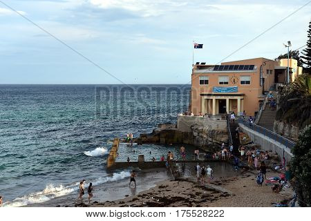 Sydney Australia - Feb 5 2017. Coogee Surf Life Saving Club and swimming pool with ocean view in summer time. People relaxing swimming and sun bathing on Coogee beach.