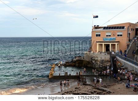 Sydney Australia - Feb 5 2017. Coogee Surf Life Saving Club and swimming pool with ocean view in summer time. People relaxing swimming and sun bathing on Coogee beach.