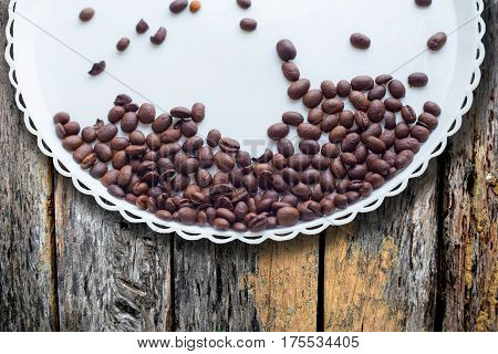 Coffee Beans On A White Plastic Plate. On Beautifull Wooden Background. Love. Insparation. On White