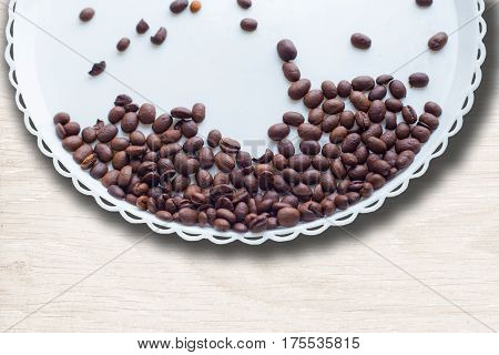 Coffee Beans On A White Plastic Plate. On Beautifull Wooden Background. Love. Insparation. On White
