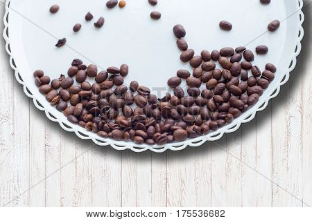 Coffee Beans On A White Plastic Plate. On Beautifull Wooden Background. Love. Insparation. On White