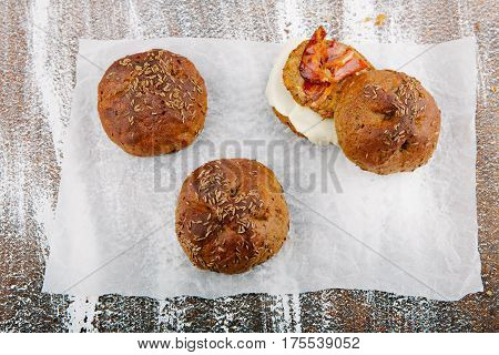 variety of small breads with seeds on grille