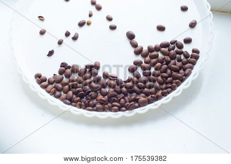 Coffee Beans On A White Plastic Plate. Beautifull Background. Love. Insparation. On White Plate.
