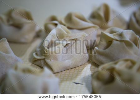 Preparation Of Manti On A Kitchen Wooden Board. Traditional Asian Dumplings