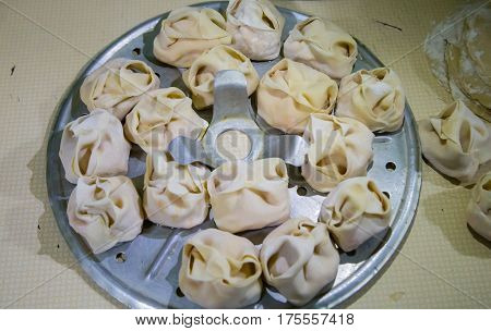 Preparation Of Manti On A Kitchen Wooden Board. Traditional Asian Dumplings