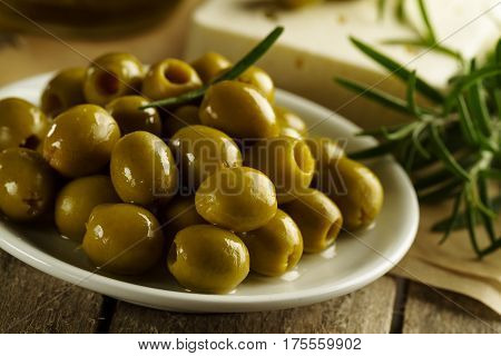Fresh tasty greek green olives with cheese feta or goat cheese. Closeup. Mediterranean food.