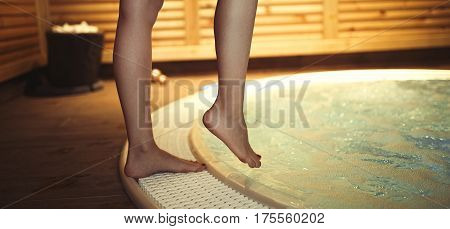 Woman Entering Jacuzzi In Spa Resost