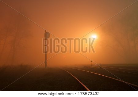 Gloomy railway in the fog at night