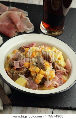 Traditional Irish dish Dublin coddle with sausages and beer on a table