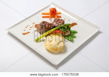 Medallions Of Grilled Veal With Potatoes And Broccoli.