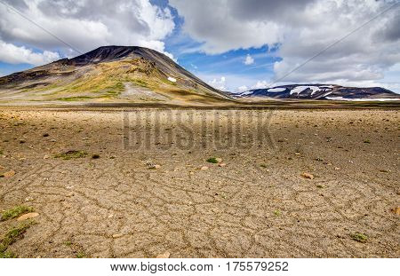 Patternd ground with polygons in beautiful primordial icelandic highland on a clear sunny day with blue sky and white clouds. Kaldidalur, Iceland.