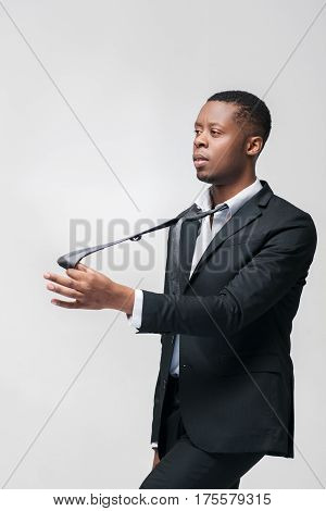 Office worker puppet unable to express opinion and will. African american employee on grey background with free space.