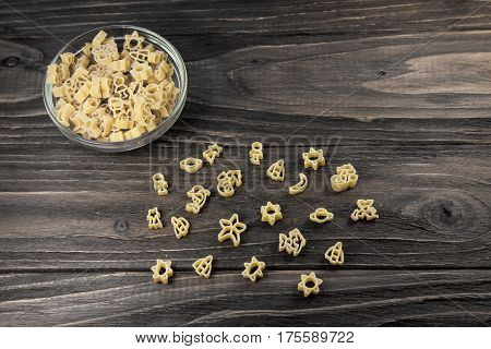 Raw macaroni on an old wooden table. Mix pasta. Background