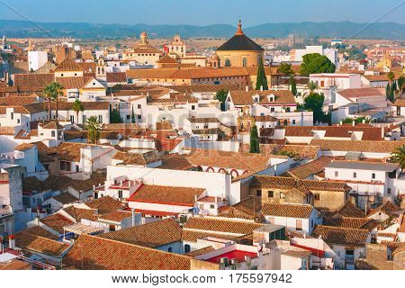 Roof of the old city and church Iglesia del Colegio de Santa Victoria, aerial view from the bell tower at the Mezquita in Cordoba, Andalusia, Spain