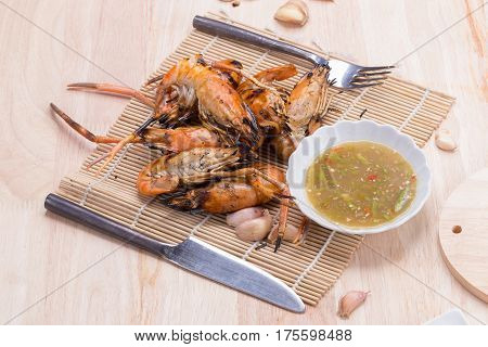 Burn Shrim And Seafood Sauce On Wooden Table.