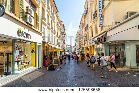 Antibes, France - June 27, 2016: day view of main street Rue de la Republique with tourists in Antibes France. Antibes is a popular seaside town in the heart of the C