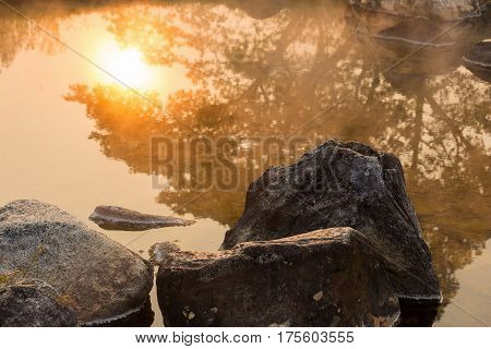 Sun reflecing on the Hot spring at national park during sunrise Thailand