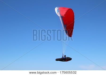 Paragliding in a blue gradient sky. flying