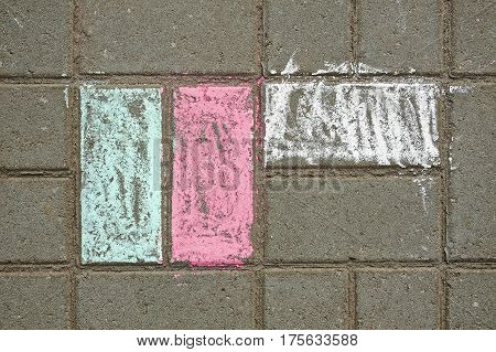 Colored chalk on the pavement tile. Texture.