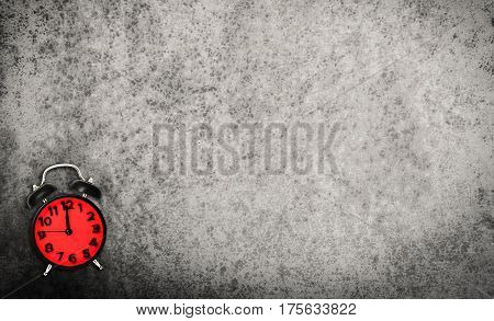 Red Vitnage Clock on grunge cement background copy space