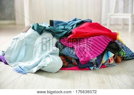 Pile of colorful clothes on floor indoors