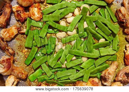 Paella from Spain recipe process ad vegetables green beans and garrofon