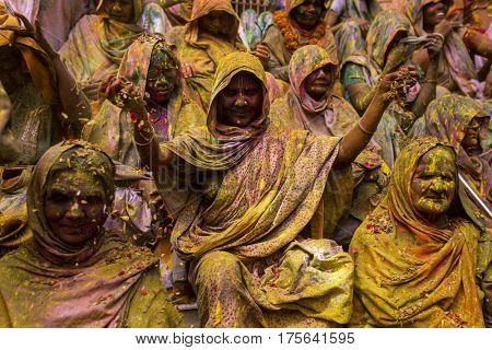Vrindavan, India - March 21, 2016: An Indian widow celebrating Holi, the Hindu spring festival of colours, at Gopinath Temple in Vrindavan, Uttar Pradesh, India.