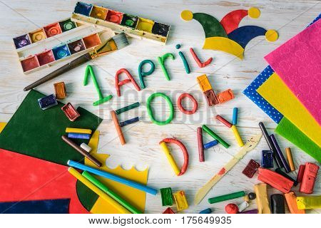 April Fools' Day text made with plasticine on white wooden background