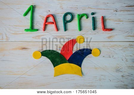 April Fools' Day text made with plasticine on white wooden background