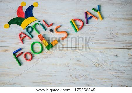 April Fools' Day text made with plasticine on white wooden background
