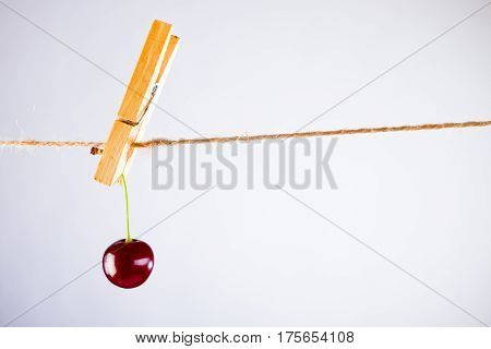 Red Cherry and rope on white with clamp fruit concept - desert, food