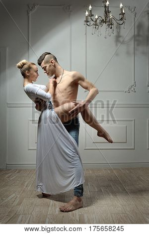 Young guy and girl dancing in a beautiful blonde and brunette dress
