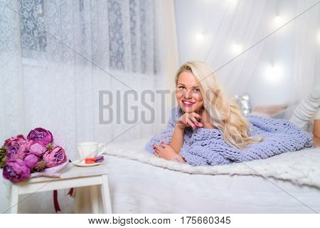 blonde in Lace Pullover Sweater looking at the camera