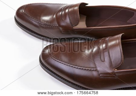 Footwear Concepts. Closeup of Pair of Stylish Brown Penny Loafer Shoes Against White Background. Above View. Horizontal Image