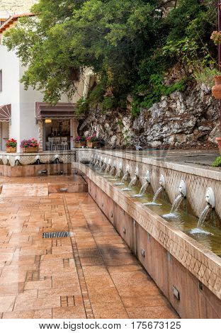 Old venetian fountain with lion heads springs pure drinking water in Spili Crete Greece