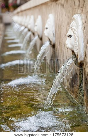 Old venetian fountain with lion heads springs pure drinking water in Spili Crete Greece
