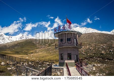 Sost Pakistan - 5 July 2009: Chinese border control tower set against the Karakoram mountains at Khunjerab Pass