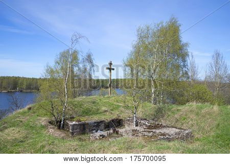 Memorial cross and the ruins of the observation post on the highest point of the fortress city of Vysotsk, Russia
