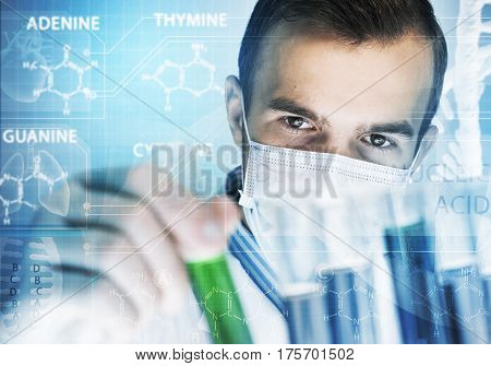 Young scientist mixing reagents in glass flask in clinical laboratory