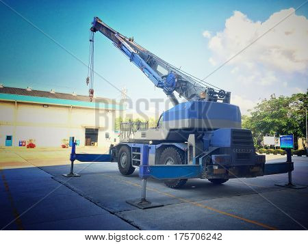 Crane car stop on the heavy factory field.