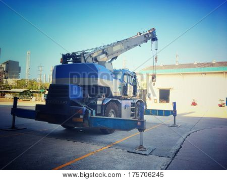 Crane car stop on the heavy factory field.