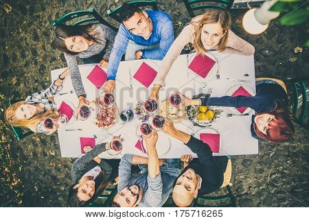 Group of friends at restaurant outdoors - People having dinner in a home garden