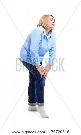 Senior woman suffering from pain in leg, on white background