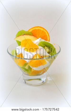 Dessert - fruit with cream, kiwi, apple and orange