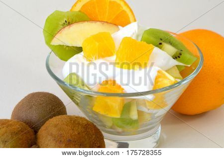 Dessert - fruit with cream, kiwi, apple and orange
