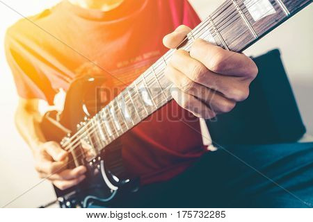 Close up shot of the man playing electric guitar