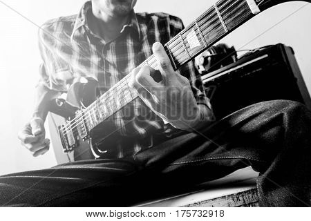The man playing electric guitar Black and white