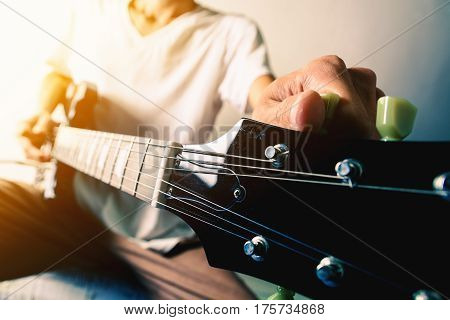 Close up shot of the man playing electric guitar
