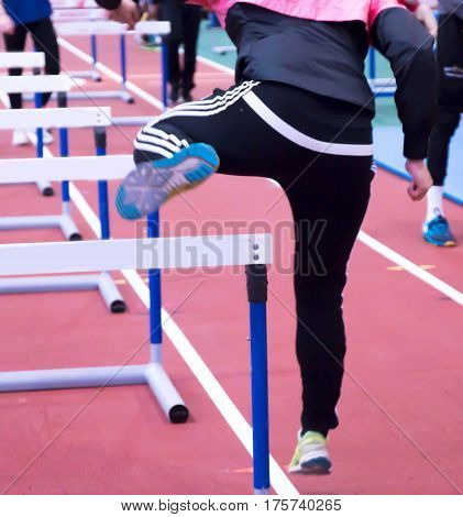 An athlete warming up for the hurdles at a track and field competition