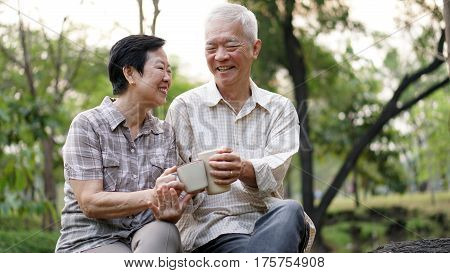 Start Day With Morning Coffee, Asian Senior Retired Couple Sitting In Green Copy Space